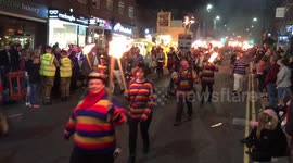 Scores march through English town with torches for bonfire season