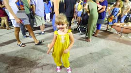 Adorable little girl dancing on the streets during Bugibba Carnival in Malta