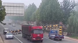 Car narrowly avoids being flattened by barrier knocked down by truck in China