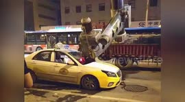 Three-ton drill lands on taxi after falling off truck in China