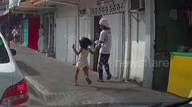 Too cute! Two young daughters chase after their father to kiss him goodbye