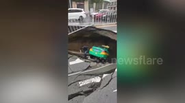 Huge sinkhole swallows taxi after opening up on Chinese road