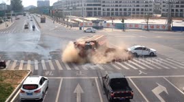 Car narrowly avoids being crushed by truck that flipped over on Chinese road