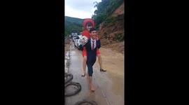 Groom carries bride on his back after landslide blocks road in Vietnam
