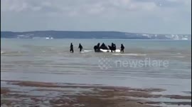 Small boat carrying 19 migrants, including children, lands on British beach