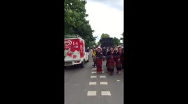 Thai cop dances while directing traffic during folk song procession