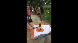The men use wooden hammers to create Vietnamese Sticky Rice Cake