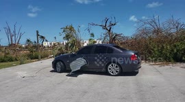 Metal roof impales car in Treasure Cay, Abaco during Hurricane Dorian