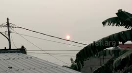 the sun in the meadow was orange because it was covered in haze