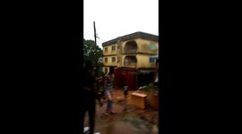 Shocking moment three-storey block collapses in Nigeria after downpour