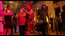 people dancing outdoors at a street festival in barcelona