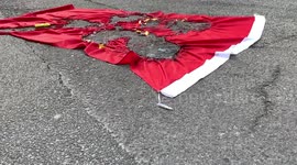 A Chinese flag finished burning on Lockhart road as a massive anti-government protest takes the lace.