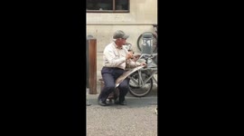 Busker Playing a Musical Saw in Oxford