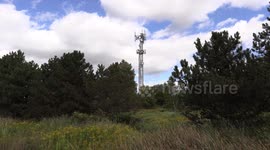 Cell tower antenna in Markham Ontario with blue sky and puffy white clouds