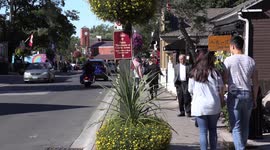 Main street small town Canada on a sunny autumn day with people out walking about