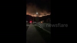 Emergency services at the scene as wildfire rages in California