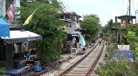 Residents live alongside train tracks in Bangkok slum facing demolition