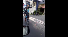 Dog Rides On Bicycle To The Beach In Bali