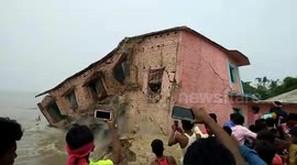 Moment school building gets washed away by river ganga in Northern India.