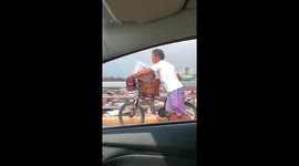 A handicapped peddler is forced to cross Mactan bridge on foot instead of biking