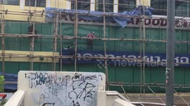 Workers Climb On Bamboo Scaffolding In Bare Feet