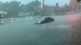 Cars flooding during storm surge from Imelda