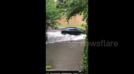 Waterlogged cars struggle to drive on flooded Houston roads
