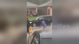 Houston kids are NOT having it with flooded roads as they 'clean up' with mop, rake and leaf blower
