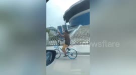 Chinese man spotted cycling with IV drip attached to him