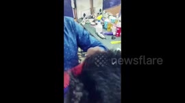 Barber gives his customer a stylish hair trim using a cigarette lighter