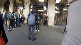 Customers depart Apple stores in London with new iPhones in hand