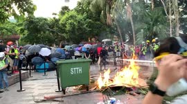 Protesters create a burning barricade to stop police clearance