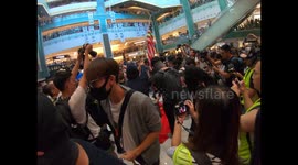 Protesters trample and dance over a Chinese flag in New Town Plaza mall in Shatin, Hong Kong