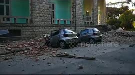 Destroyed cars lie next to damaged building after earthquake hits Tirana, Albania