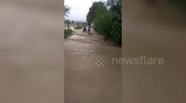 Biker has brush with death while crossing inundated road in northern India