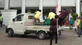 Demonstrators fall out of own protest vehicle when it stalls mid-march in Indonesia