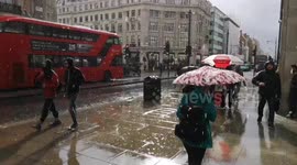 Heavy rain in Oxford Street causes commuter problems