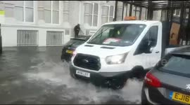 Flash flood turns London streets into river after heavy downpour