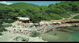 people on the beach in the small cala olivera, ibiza, spain