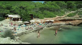 people on the beach in the small cala olivera, ibiza, spain