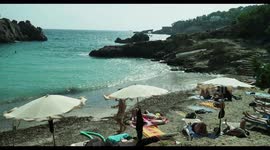 people on the beach in the small cala olivera, ibiza, spain