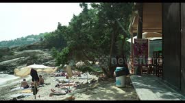 people on the beach in the small cala olivera, ibiza, spain