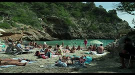 people on the beach in the small cala olivera, ibiza, spain