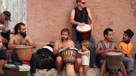 hippy drummers play on benirras beach during the summer in ibiza, spain
