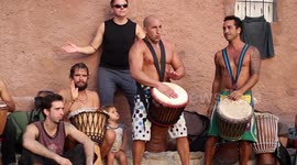 hippy drummers play on benirras beach during the summer in ibiza, spain