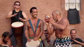hippy drummers play on benirras beach during the summer in ibiza, spain