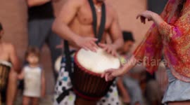 hippy drummers play on benirras beach during the summer in ibiza, spain
