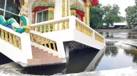 Buddhist temple collapses into a river after weeks of heavy rain