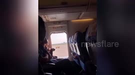 Chinese woman causes delay on flight by opening emergency exit for 'fresh air'
