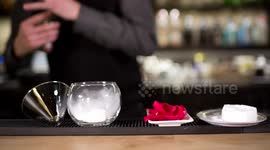 an experimental cocktail waiter makes a special drink in a bar lounge in spain